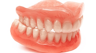 Close-up of full dentures in for upper and lower arches